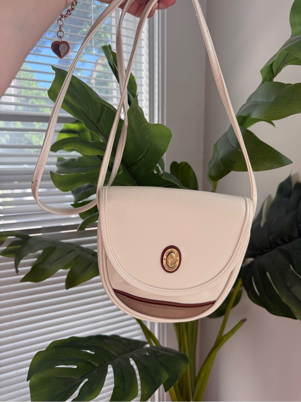 Cream Crossbody Saddle Bag with Gold Medallion and Brown Trim